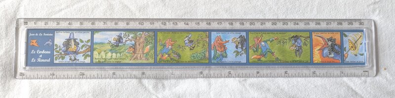A blue ruler with scenes of a fox and a crow.