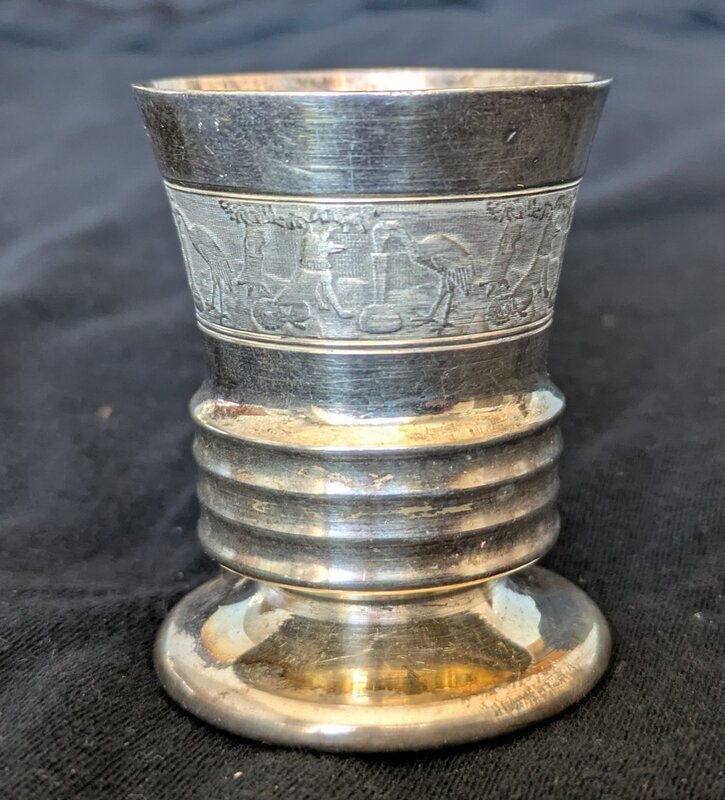 Silver cup with etchings